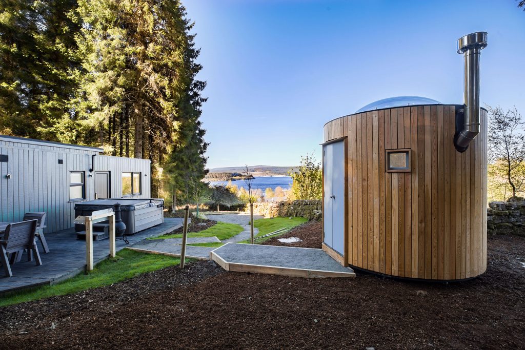 Beech Platinum Stars at Kielder Waterside. View of the single story lodge with stargazing pod in view.