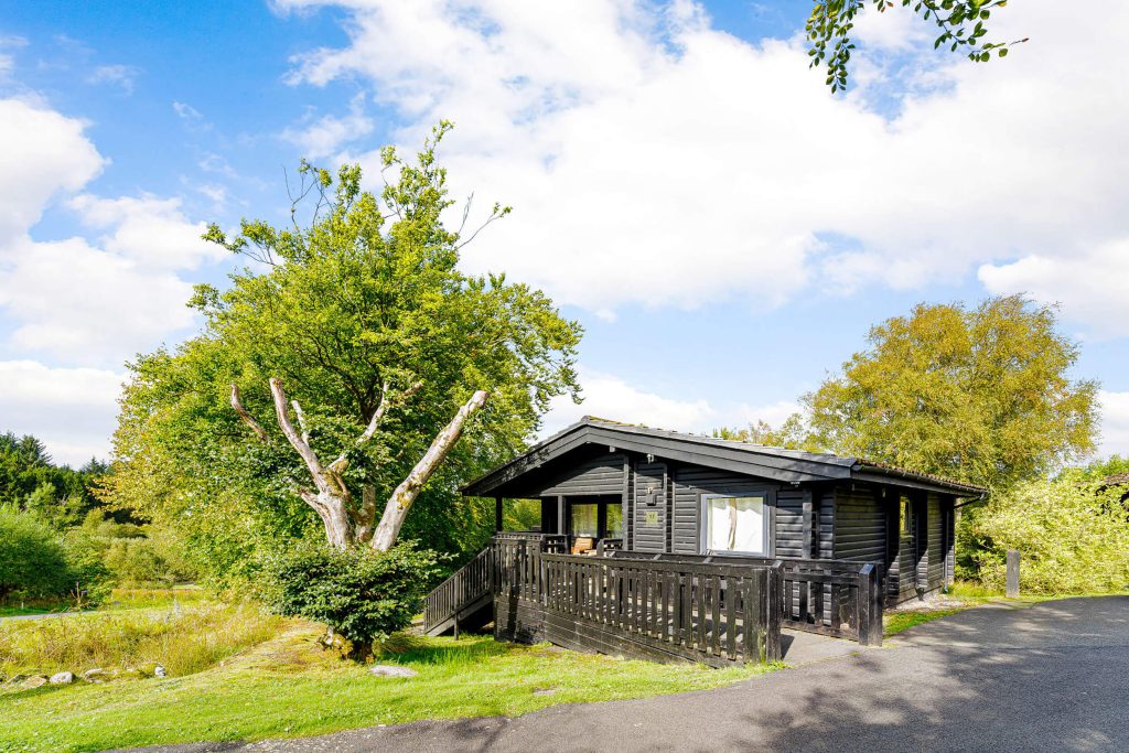 Falstone BBQ at Kielder Waterside. Outdoor shot of the single story lodge.