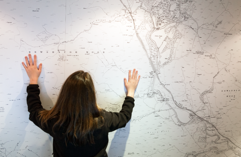 Tower Knowe Kielder Waterside - Young girl looking at big map of Kielder Water